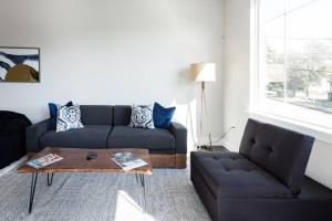 a living room with a couch and a coffee table at Capitol View Condos by One Fine Bnb - Paramount in Austin