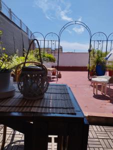 a patio with a table with a basket of plants at Penthouse Pza España - 4th Floor in Barcelona