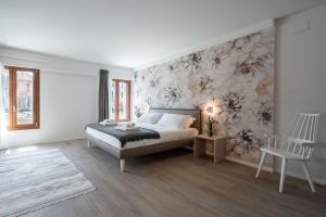 a bedroom with a bed and a wall with flowers at Palace Canal View by Wonderful Italy in Venice