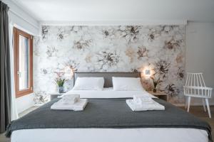 a bedroom with a large bed with a floral wallpaper at Palace Canal View by Wonderful Italy in Venice +72 photos