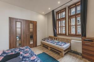 a small bedroom with a bed and a window at Carolina's CENTRAL Apartment in Hradec Králové