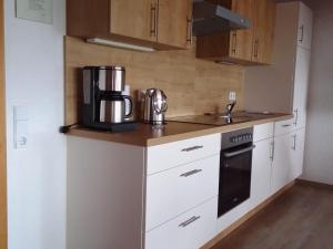 a kitchen with a coffee maker on a counter at Holiday flat with balcony in Black Forest in Furtwangen