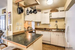 a kitchen with white cabinets and a black counter top at ON THE STRIP - Classic Comfort - 2 Bedroom Condo in Las Vegas