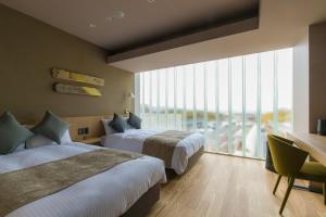 um quarto de hotel com duas camas e uma grande janela em Spa & Hotel Suishun Matsuiyamate em Quioto