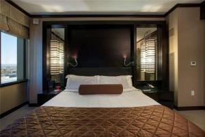 a bedroom with a large bed and two windows at Perfect - Lux 1BR Suite at Vdara in Las Vegas