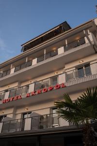 a building with a sign on the side of it at Hotel Akropol in Paralia Katerinis