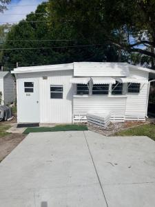 a white house with a garage in a driveway at Home in Arbor Terrace Resort in Bradenton