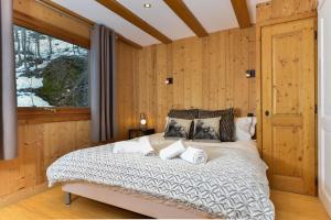 a bedroom with a large bed with wooden walls at Chalet Chardonnet in Chamonix