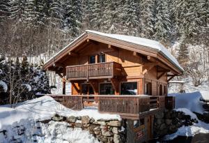 a log cabin in the snow with snow at Chalet Chardonnet in Chamonix