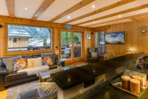a living room with a couch and a large window at Chalet Chardonnet in Chamonix