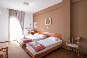 Posteľ alebo postele v izbe v ubytovaní Hotel Akropol