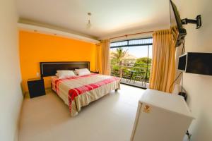 a bedroom with a bed and a large window at Hotel Rumi Wasi in Lunahuaná