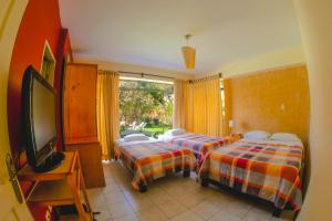Postel nebo postele na pokoji v ubytování Hotel Rumi Wasi