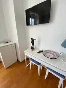 a white table with a small statue on top of it at Capri Inn in Capri