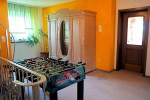 a room with a foosball table in front of a cabinet at Ferienhof Zum Rössberg in Geisa