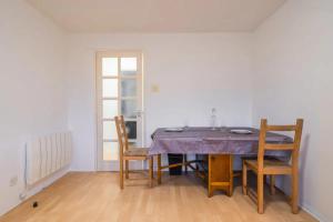 a dining room with a table and two chairs at 1BD Flat - Prime Location Surrey Quays in London