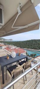 a blue table and chairs on a balcony at Anna Maria Apartment in Skala Marion