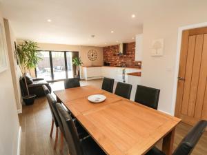 a kitchen and dining room with a wooden table and chairs at 31A The Green in Scarborough