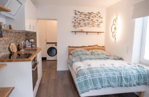 a small bedroom with a bed and a sink at Apartment Graf in Bad Aibling