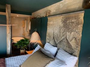 a bedroom with a bed with a large headboard at La Cambrousse 