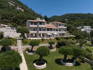 a large building with trees in front of it at Nissaki Bay in Nisakion