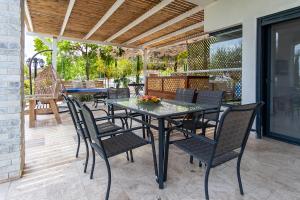 a dining table and chairs on a patio at Mother Nature - Gilboa in H̱efẕi Bah