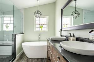 a bathroom with two sinks and a mirror at Modern Fishtown Townhouse in Philadelphia