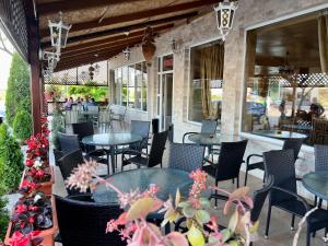 patio restauracji ze stołami i krzesłami w obiekcie Hanul Kartali w mieście Lumina