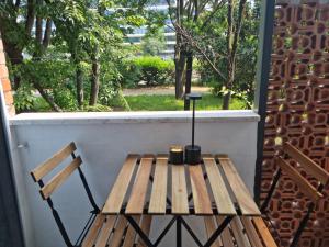 a wooden bench sitting on a porch with a window at Da Nord a Sud - Affittacamere in Milan