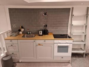 a kitchen with a sink and a counter top at Top floor Warren st flat. in London