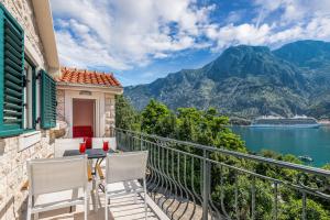 a balcony with a view of the water and mountains at Apartments Dončić in Kotor