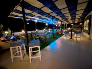a rooftop restaurant with tables and chairs at night at La Boutique Residence in Hurghada +20 photos