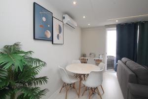 - un salon avec une table, des chaises et un canapé dans l'établissement Praia_da_Rocha_Vista_Mar/Ocean_View, à Portimão