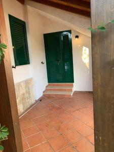 a room with two green doors and a tile floor at Villa Monica appartamenti in Vieste +76 photos