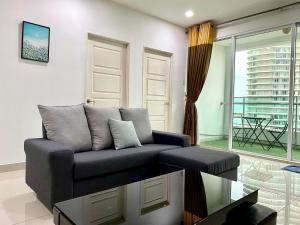 a living room with a couch and a table at Mansion One Suite by stayCATion Homestay in George Town