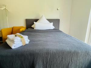 a bed with a black and white comforter and pillows at City - Business - Appartement in Bielefeld