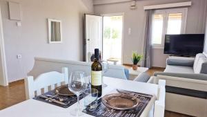 a bottle of wine on a table in a living room at My Cretan Village by Go4sea in Chorafakia