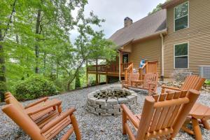 a patio with chairs and a fire pit in front of a house at Luxe Blairsville Cabin with Game Room, Near Hikes in Hood