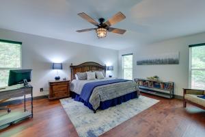 a bedroom with a bed and a ceiling fan at Luxe Blairsville Cabin with Game Room, Near Hikes in Hood