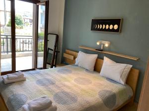 a bedroom with a bed with a view of a balcony at Kristel in Ierissos