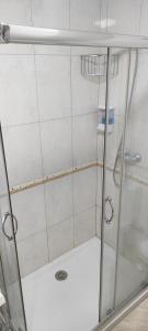 a shower with a glass door in a bathroom at Piso As Rodas in Villanueva de Arosa