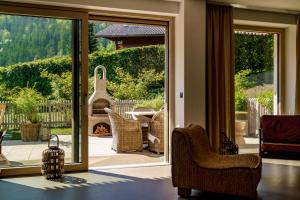 a living room with a sliding glass door to a patio at CHILL HOUSE in Schladming +48 photos