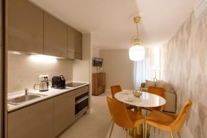 a kitchen with a table and a dining room at Casa Carmela Apartments in Bardolino
