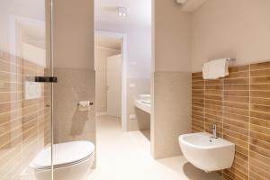 a bathroom with a toilet and a sink at Casa Carmela Apartments in Bardolino