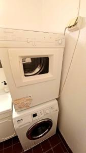 a washer and dryer in a small room at Tromso Coco Apartments in Center in Tromsø