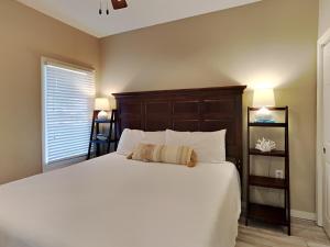 a bedroom with a large white bed and a window at Tidewater Orange Beach #209 in Orange Beach +17 photos