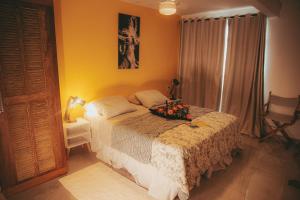 a bedroom with a bed with a flower arrangement on it at Eco Pousada Estrelas da Babilônia in Rio de Janeiro