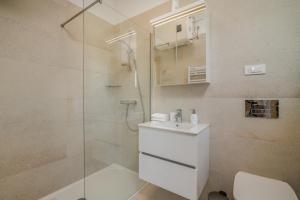 a bathroom with a shower and a toilet and a sink at Apartment Marko in Malinska +28 photos