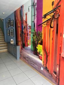 a hallway with a painting of a street at ArtMotel & Bistro in Haţeg