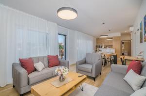 a living room with a couch and a table at Apartment Marko in Malinska